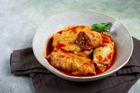 Stuffed cabbage rolls with minced meat, in tomato sauce, top view, without people, in the spotlight