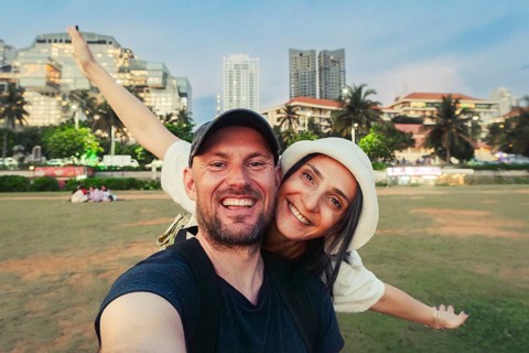 Cute happy caucasian couple enjoy travel freedom pose looking at camera explore Sri lanka city