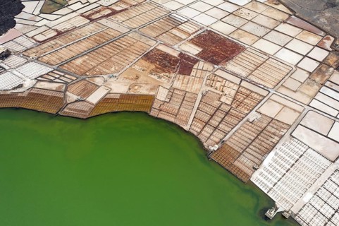 Vibrant aerial shot capturing the diverse color palette of the Los Salares de Janubio in Lanzarote,