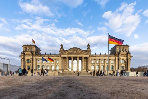Reichstag building Berlin with German flags. Exterior view. Berlin, Germany