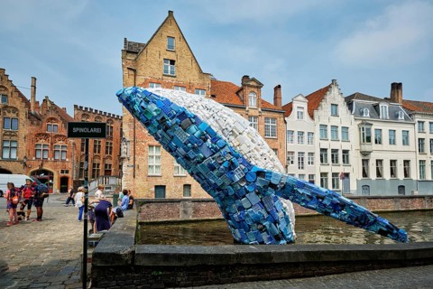 BRUGES, BELGIUM, MAY 29, 2018: Skyscraper or The Bruges Whale, whale rising up from the Canal