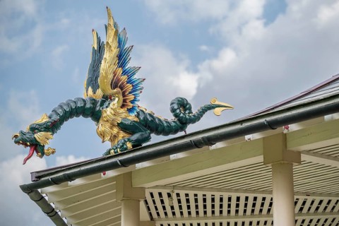 Close-up of a gold-blue-red painted dragon statue, historic large pagoda, Royal Botanic Gardens