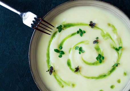 Mashed potatoes, with green butter, micro greenery, homemade, on a dark background, no people, top