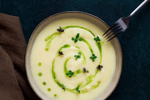 Mashed potatoes, with green butter, micro greenery, homemade, on a dark background, no people, top