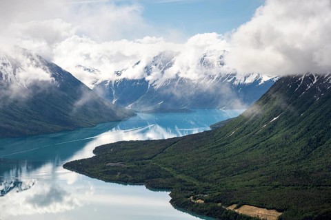 View of snowy mountains in spring and turquoise Kenai Lake with reflection, Slaughter Ridge Trail,