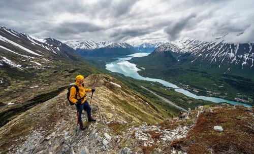 Climbers on a hiking trail on Slaughter Ridge, views of snowy mountains in spring and turquoise