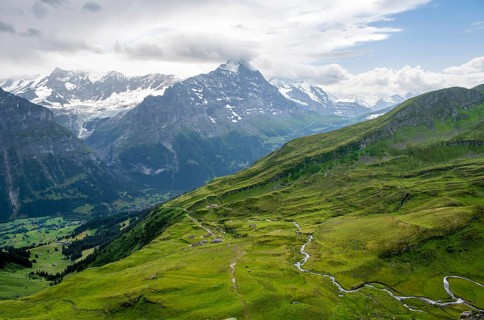 View of mountain landscape with green meadows and alpine huts Bachlager, Grindelwald First,