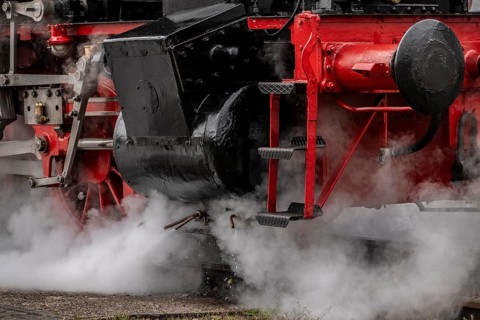 Detailed view of the drive wheels and coupling rods of a steam locomotive, Bochum railway museum,
