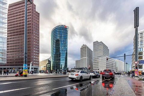 Potsdamer Platz Berlin in the evening with traffic on the streets. When it rains, the skyscrapers