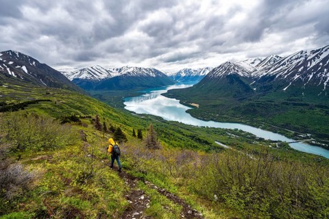 Climbers on a hiking trail, Slaughter Ridge Trail, view of snowy mountains in spring and turquoise