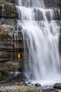 Adventure, Little hiker under large Cascata di Mezzo waterfall, long exposure, Vallesinella,