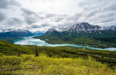 View of snowy mountains in spring and turquoise blue Kenai Lake, Slaughter Ridge Trail, Cooper