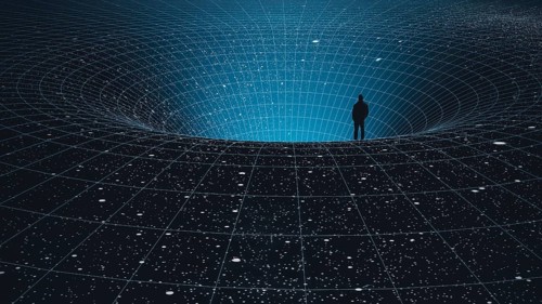 A man stands at the edge of a black hole, gazing into the depths of the universe, surrounded by
