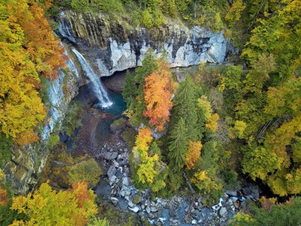 Aerial view of Berglistüber waterfall in autumn-colored surroundings, Linthal, Klausenpass, Canton