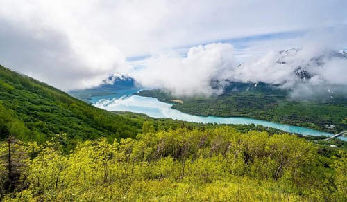 View of snowy mountains in spring and turquoise blue Kenai Lake, Slaughter Ridge Trail, Cooper