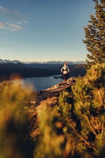 Trail running in autumn on the Jochberg on Lake Walchensee against the wonderful backdrop of the