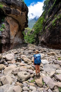 Female hiker in the Tugela Gorge or Tugela Gorge in the riverbed, Drakensberg National Park,