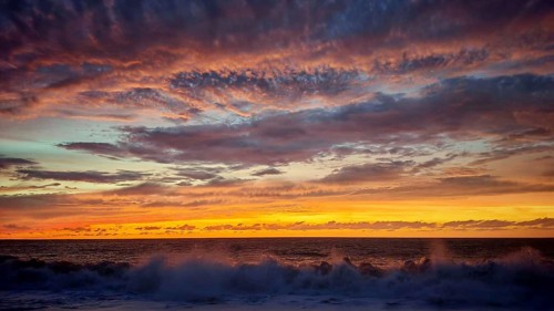 Dramatic sunset with powerful cloud formations and breaking waves in the foreground, Tarrafal de