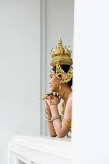 Thai traditionally and festively dressed young woman, Wat Pho, Bangkok, Thailand