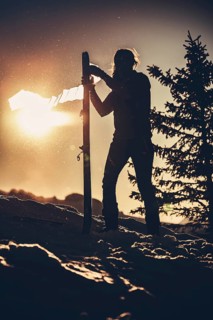 A woman's ski tour at sunrise on the Tegelberg in the Allgäu in the Ammergebirge, Bavaria, Germany