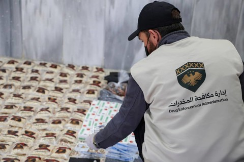 Personnel from the Syrian Anti-Narcotics Directorate display a massive cache of confiscated illegal