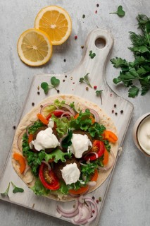 Tortilla with falafel and vegetable salad, white sauce, Arabic cuisine, top view, homemade, no