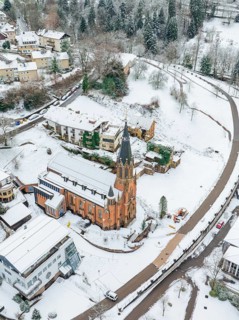 Aerial view of a snow-covered village with church and surrounding houses, St.Bonifatius, Catholic