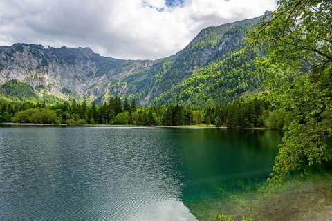 Landscape of Lake Offensee after rain when the sun comes through the clouds in spring,
