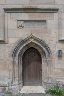 Entrance portal of the Gothic St Mary's Church, on the left the coat of arms of the patrician