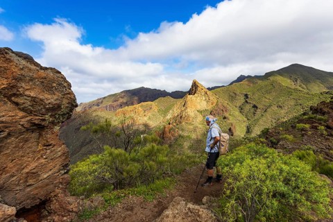 Mountain hike over Santiago Valley, Montana de Guama, hiker with view to Risco Blanco, Tenerife,