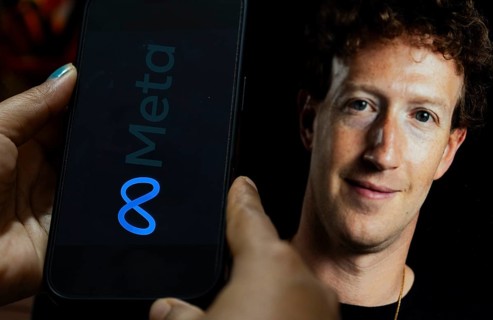 In this photo illustration, a smartphone displays the Meta logo on its screen with an image of Meta