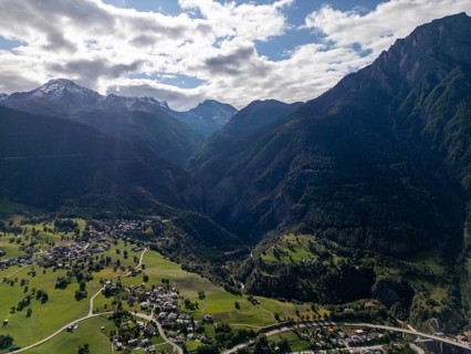 A breathtaking aerial view of the Brig area in Switzerland, showcasing lush green valleys,