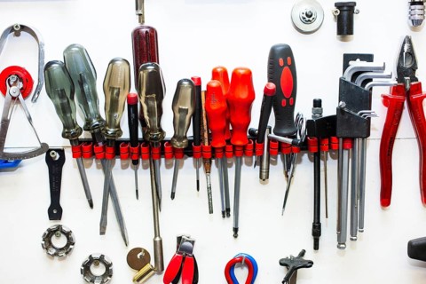 Various tools in a holder on a white wall, Düsseldorf, Germany