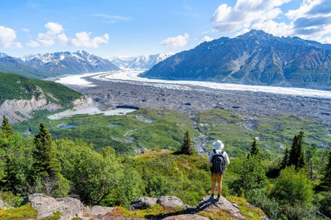 Young man enjoying the view, view of impressive mountain landscape with Matanuska glacier and