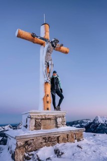 Summit bliss in the snow-covered winter landscape in the Tannheimer Tal in the Alps on the
