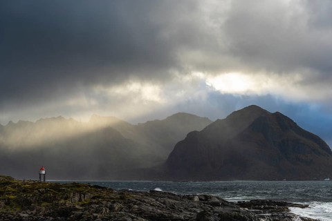 Sunbeams over coastal landscape and sea, Lofoten, Nordland, Norway, September 2020