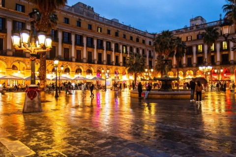 Nightlife at Plaça Reial, lanterns by Gaudi in the historic centre of Barcelona, Spain