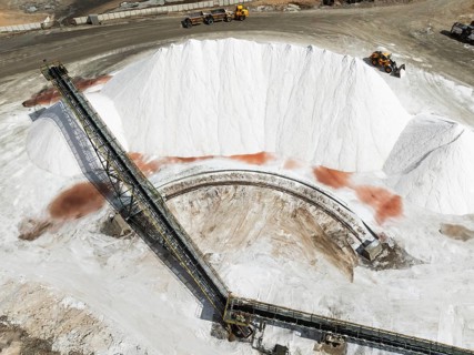 Conveyor belt and salt heaps at the Walvis Bay Salt works. Aerial view. Drone shot. Walvis Bay,