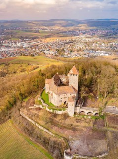 Castle on a wooded hill with town in the background, autumn atmosphere, Lichtenberg Castle,