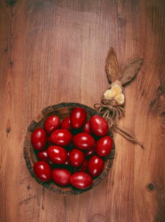 Painted eggs in a wooden bowl, red, painted madder dye, powder from the roots of endro, with onion