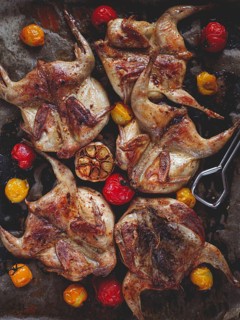Grilled quail meat, on a platter, tobacco, in the oven, with spices, homemade, without people