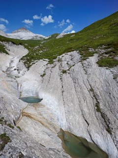 Glacier mill with glacier pots on the Trinser Alp Mora, Trin, Canton Graubünden, Switzerland