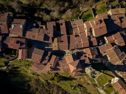 Aerial image of a charming historic village with traditional terracotta rooftops in Montserrat,