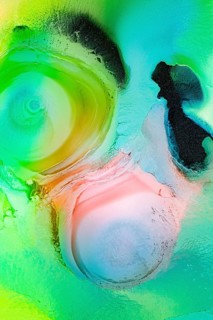 This image showcases an abstract composition with liquids patterns in vibrant green, pink, and blue