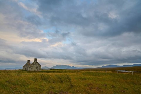 Stone house in peaceful evening landscape with clouds in the sky, Moine House, Lairg, Scotland,
