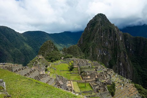 A breathtaking view of the ancient Inca city of Machu Picchu in Peru, nestled between lush green