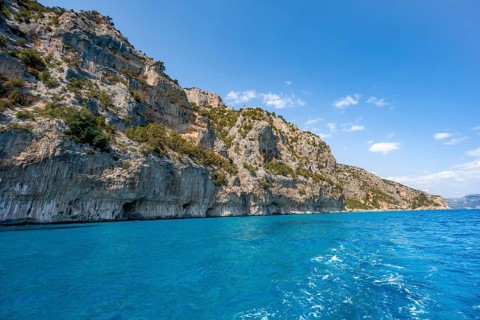 Picturesque rocky coast, cliffs and blue sea, Golfo di Orosei, Baunei, Sardinia, Italy