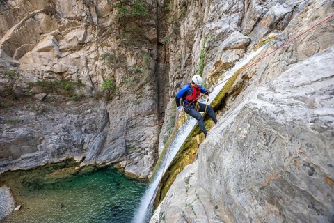 Enthusiastic canyoneer participates in exciting canyoning and rappelling activities in Matacanes,