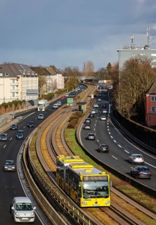Essen, North Rhine-Westphalia, Germany - Cars and a public bus drive through Essen city centre on