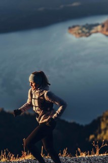 Trail running in autumn on the Jochberg on Lake Walchensee against the wonderful backdrop of the
